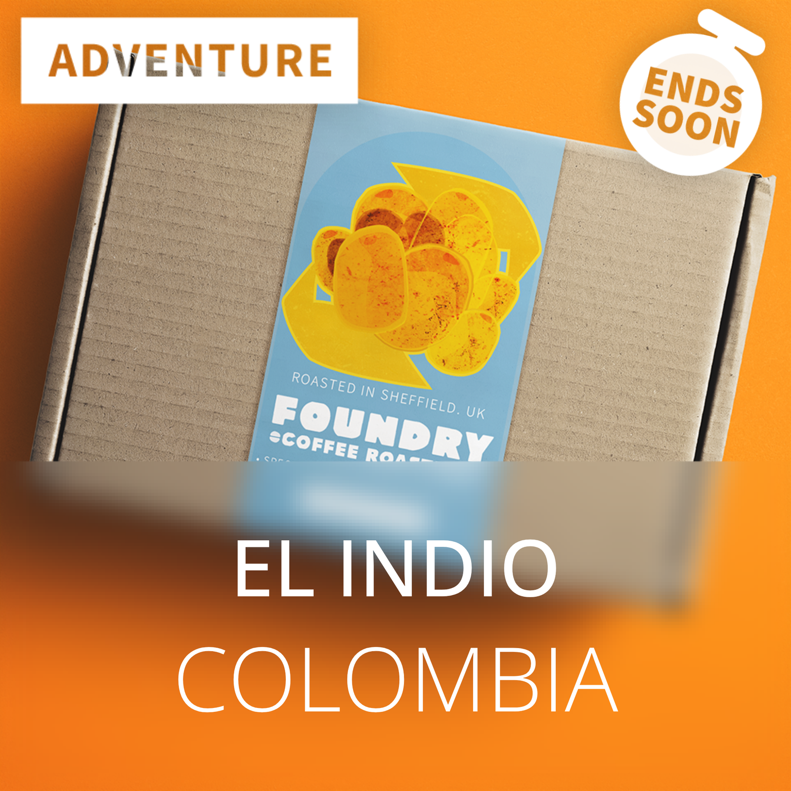 A cardboard box with a blue and yellow label reading 'Foundry Coffee Roastery' and 'El Indio Colombia,' set on an orange background with 'Adventure' and 'Ends Soon' promotional badges.
