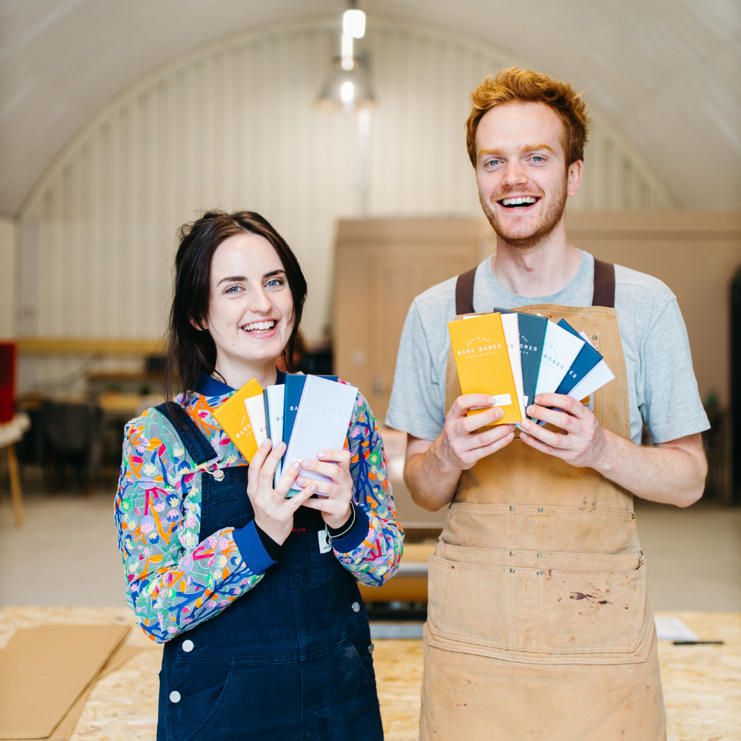 The founders of Bare Bones smiling into the camera. 