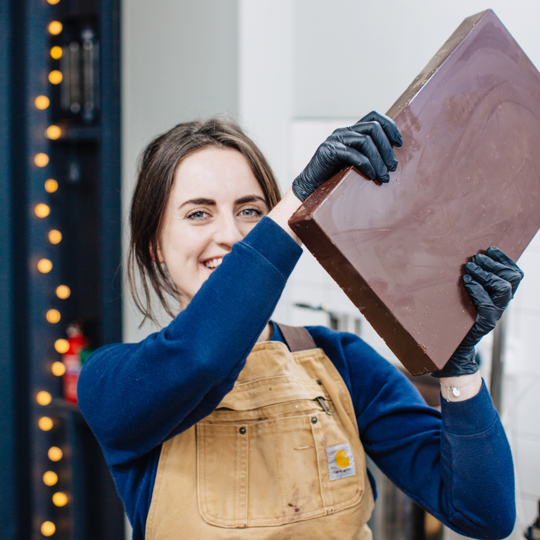 One of the bare bones founders holding a giant bag of hot chocolate