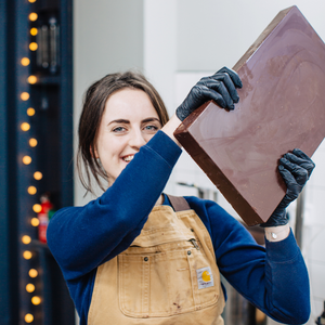 One of the bare bones founders holding a giant bag of hot chocolate