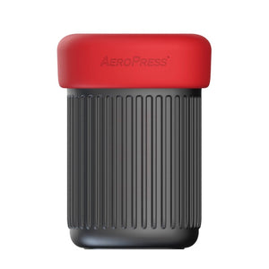 the Aeropress Go mug, black and with a red lid