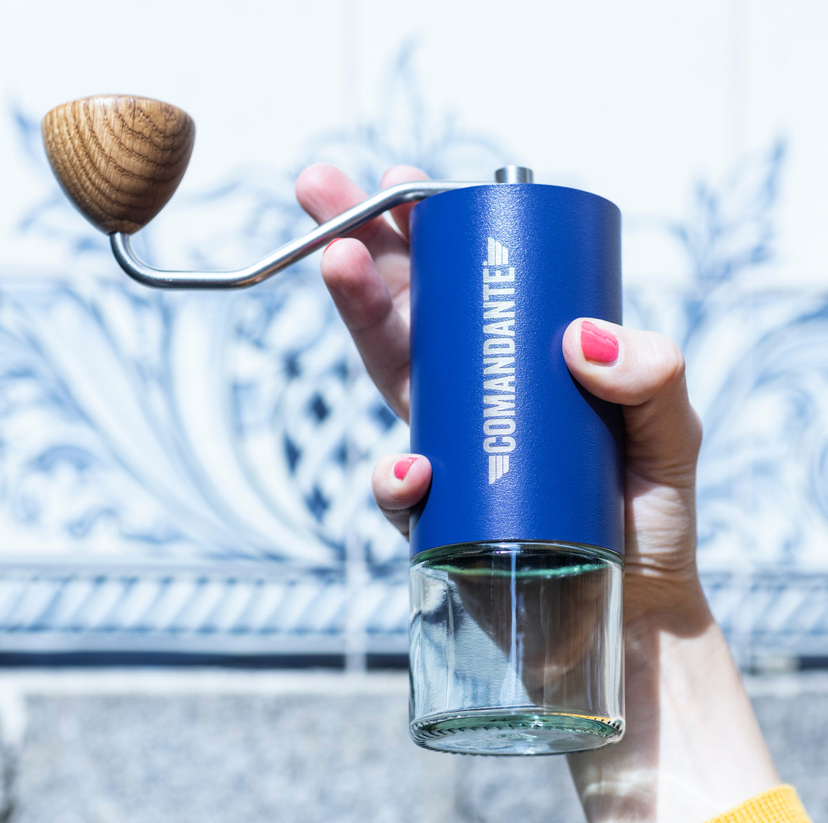 Man holding a Comandante grinder in blue finish