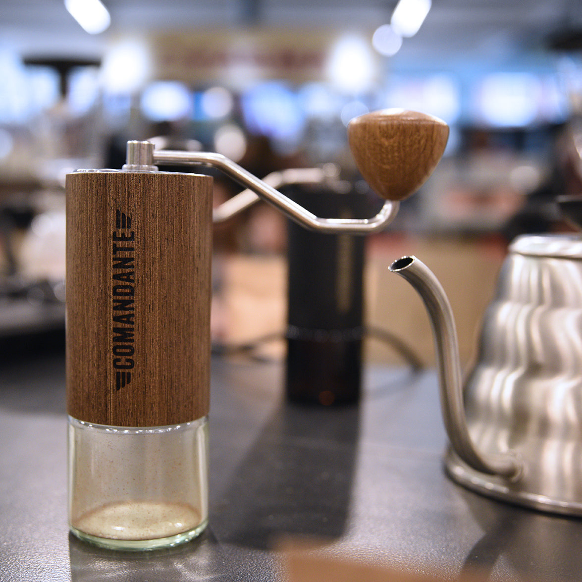 wooden Comandante grinder on a table. 